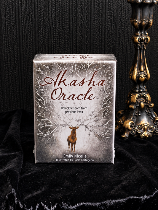 Akasha Oracle by Emily Nicolle, illustrated by Carla Cartagena, featuring a stag with branching antlers against an intricate grey woodland background.