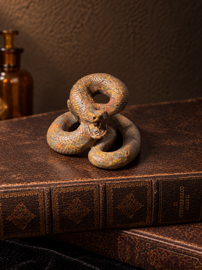 Polished jasper snake carving with raised open-mouthed head, coiled body and earthy orange and grey markings.
