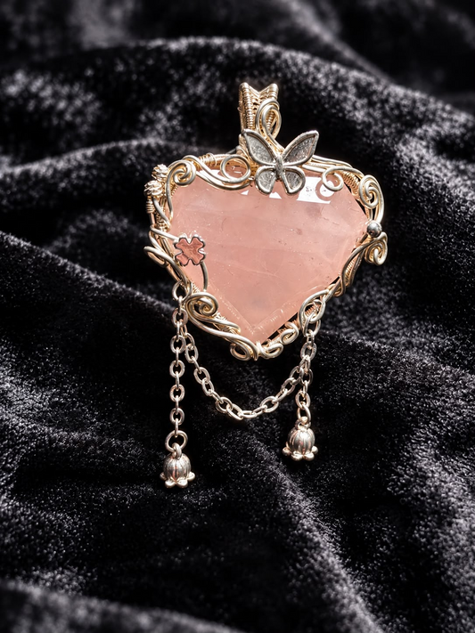 Handmade Madagascan Rose Quartz heart pendant with ornate wire wrapping, butterfly decoration and hanging charms