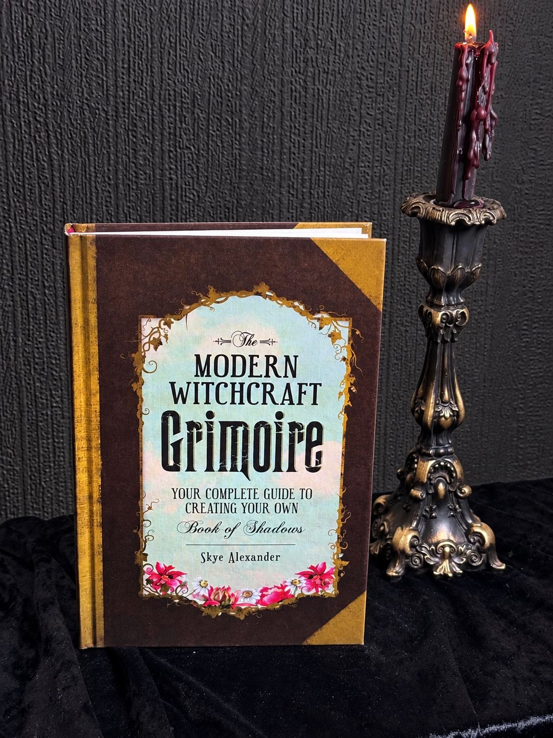 The Modern Witchcraft Grimoire by Skye Alexander, hardcover book with antique-style brown and gold cover and decorative title panel.