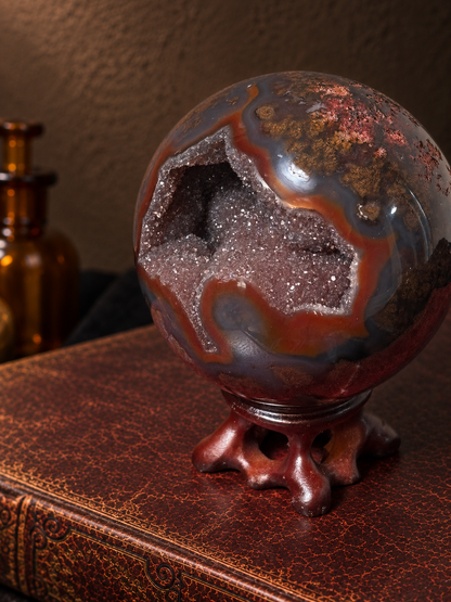 Close-up of sparkling druzy cavity in scenic moss agate with concentric reddish-brown bands and natural mineral inclusions.
