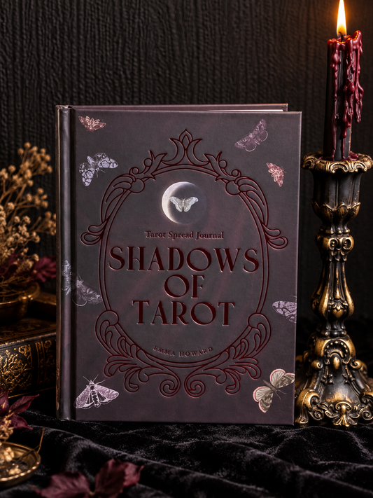 Shadows of Tarot hardback tarot spread journal by Emma Howard, featuring a dark burgundy cover with embossed ornamental details, moth illustrations and a central moon motif.