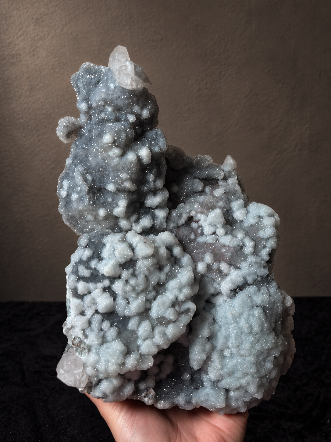 Reverse view of a large Xianghualing mineral specimen showing branching grey chalcedony formations and pale crystalline growth.
